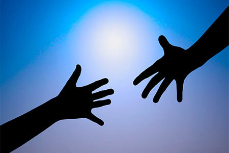 Hands reaching together